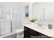 Bright bathroom features a glass-enclosed shower, dark vanity, and a window providing natural light at 200 J.P. Dr # 184P, Albemarle, NC 28001