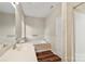 Well-lit bathroom features large bathtub, shower, vanity sink, and white tiled walls at 2009 Whippoorwill Ln, Indian Trail, NC 28079