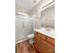 Bathroom featuring a shower with glass door, sink and vanity with brown wood cabinets at 2009 Whippoorwill Ln, Indian Trail, NC 28079