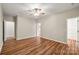 Spacious bedroom with wood floors, ceiling fan, and neutral walls, offering a comfortable retreat at 2009 Whippoorwill Ln, Indian Trail, NC 28079