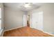 Bright bedroom with wood floors, ceiling fan, and double-door closet, offering a comfortable retreat at 2009 Whippoorwill Ln, Indian Trail, NC 28079