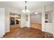 Dining area featuring hardwood floors and an elegant chandelier at 2009 Whippoorwill Ln, Indian Trail, NC 28079