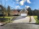 Inviting brick home with a spacious driveway and manicured front yard at 2009 Whippoorwill Ln, Indian Trail, NC 28079