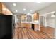 Well-lit kitchen with wooden cabinets and a black refrigerator at 2009 Whippoorwill Ln, Indian Trail, NC 28079
