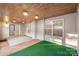 Spacious sunroom featuring tile floor and many windows providing ample natural light and a view of outdoors at 2009 Whippoorwill Ln, Indian Trail, NC 28079