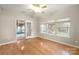 Bright sunroom with hardwood floors, ceiling fan, and multiple windows offering plenty of natural light at 2009 Whippoorwill Ln, Indian Trail, NC 28079