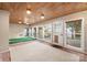 Bright sunroom features wood ceiling, tile flooring, and many windows, creating an inviting space at 2009 Whippoorwill Ln, Indian Trail, NC 28079