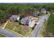 Aerial view of brick home in a wooded neighborhood at 204 Silvercliff Dr, Mount Holly, NC 28120