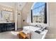 Bright bathroom with a stand alone tub below a window and a black vanity at 204 Silvercliff Dr, Mount Holly, NC 28120