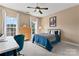 Bright bedroom with a ceiling fan, two windows, and a desk and chair at 204 Silvercliff Dr, Mount Holly, NC 28120