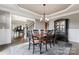 Dining room with wooden table and chairs, flowing into a formal living room at 204 Silvercliff Dr, Mount Holly, NC 28120