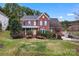 Charming two-story brick home featuring a beautifully landscaped front yard at 204 Silvercliff Dr, Mount Holly, NC 28120