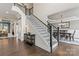 Welcoming foyer with staircase, hardwood floors, and an open view into the dining room at 204 Silvercliff Dr, Mount Holly, NC 28120