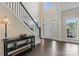 Bright foyer with high ceilings, hardwood floors, and an elegant staircase at 204 Silvercliff Dr, Mount Holly, NC 28120