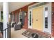 Inviting front porch featuring stylish seating and a bright yellow front door at 204 Silvercliff Dr, Mount Holly, NC 28120