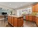 Well-appointed kitchen featuring an island, stainless steel appliances, and hanging pot rack at 204 Silvercliff Dr, Mount Holly, NC 28120
