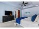Bright main bedroom with a ceiling fan, closet and a TV with a dresser at 204 Silvercliff Dr, Mount Holly, NC 28120