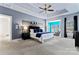 Serene main bedroom with tray ceiling, sitting area, and ample natural light at 204 Silvercliff Dr, Mount Holly, NC 28120