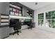 Home office with custom built-in cabinets and a view of the backyard at 204 Silvercliff Dr, Mount Holly, NC 28120