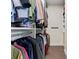 Walk-in closet with hanging shirts and pants along with shelves for storage at 204 Silvercliff Dr, Mount Holly, NC 28120