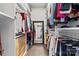 Walk-in closet with hanging shirts and pants along with drawers for storage at 204 Silvercliff Dr, Mount Holly, NC 28120