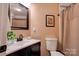 Well-lit bathroom with a clean white sink, toilet, and neutral-colored walls at 210 Keltic Meadows Dr, Gastonia, NC 28056