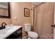 Clean bathroom features a white toilet, a neutral shower curtain and black hardware at 210 Keltic Meadows Dr, Gastonia, NC 28056