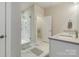 Bathroom featuring a glass shower, double vanity sinks, and modern fixtures at 2123 Isom St, Charlotte, NC 28208