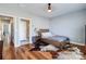 Bright bedroom featuring hardwood floors, a wooden bed frame, and an ensuite bathroom at 2123 Isom St, Charlotte, NC 28208