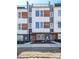 Modern townhome showcasing stylish facade, brick accents, and private rooftop terrace at 2123 Isom St, Charlotte, NC 28208