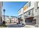 Modern townhome with a multi-tone color palette, integrated garage, and small balcony, showing contemporary curb appeal at 2123 Isom St, Charlotte, NC 28208