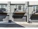 Townhome garages with minimalist balconies above and modern architectural details offer sleek and functional design at 2123 Isom St, Charlotte, NC 28208