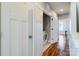 Hallway view with laundry, showcasing hardwood floors, and white doors for a clean design at 2123 Isom St, Charlotte, NC 28208