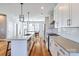 Stylish kitchen boasts stainless steel appliances, modern backsplash, and hardwood floors at 2123 Isom St, Charlotte, NC 28208