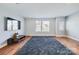 Spacious living room with hardwood floors, a modern TV, and large windows at 2123 Isom St, Charlotte, NC 28208