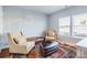 Cozy sitting area with natural light, two chairs, and a decorative rug at 2123 Isom St, Charlotte, NC 28208