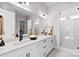 Modern bathroom featuring dual sinks, quartz countertops, sleek cabinetry, and a glass-enclosed shower at 2208 Indigo Branch Rd, Indian Land, SC 29707