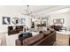 Open-concept living room with modern furniture, stylish decor, and seamless flow to dining and kitchen areas at 2208 Indigo Branch Rd, Indian Land, SC 29707