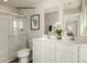 Modern bathroom with a glass shower, dual vanities, and sleek white cabinets at 221 Basildon St # 1019, Lancaster, SC 29720