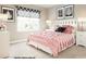 Chic bedroom with a lavish bed, bedside tables, lamps, and patterned window treatments at 221 Basildon St # 1019, Lancaster, SC 29720