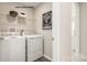 Well-equipped laundry room featuring a washer, dryer, storage shelf, and a stylish 'Get Ready to Tumble' sign at 221 Basildon St # 1019, Lancaster, SC 29720