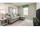 Comfortable living room with a chaise sectional, side table, and neutral walls at 221 Basildon St # 1019, Lancaster, SC 29720