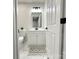 Bathroom with white marble floors, modern vanity, and a full-sized mirror at 226 Malvern Sw Dr, Concord, NC 28025