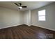 Bedroom featuring wood-look floors, neutral walls, a window, a ceiling fan, and a closet at 226 Malvern Sw Dr, Concord, NC 28025