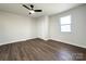 Bedroom features hardwood floors, a ceiling fan, and a large closet at 226 Malvern Sw Dr, Concord, NC 28025