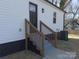 Charming view of the home's exterior with new steps leading to the back entrance at 226 Malvern Sw Dr, Concord, NC 28025