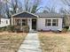 Charming single-story home features white siding, dark gray accents, and a cozy front porch at 226 Malvern Sw Dr, Concord, NC 28025