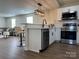 Open kitchen with stainless appliances, white cabinets and bar seating at 226 Malvern Sw Dr, Concord, NC 28025