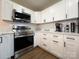 Modern kitchen with white cabinets, stainless steel appliances, and sleek countertops at 226 Malvern Sw Dr, Concord, NC 28025