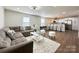 Open-concept living area seamlessly connects to a modern kitchen with breakfast bar at 226 Malvern Sw Dr, Concord, NC 28025